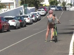 Naked on a bicycle through a town