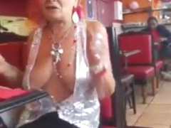 Old woman showing off her big chest